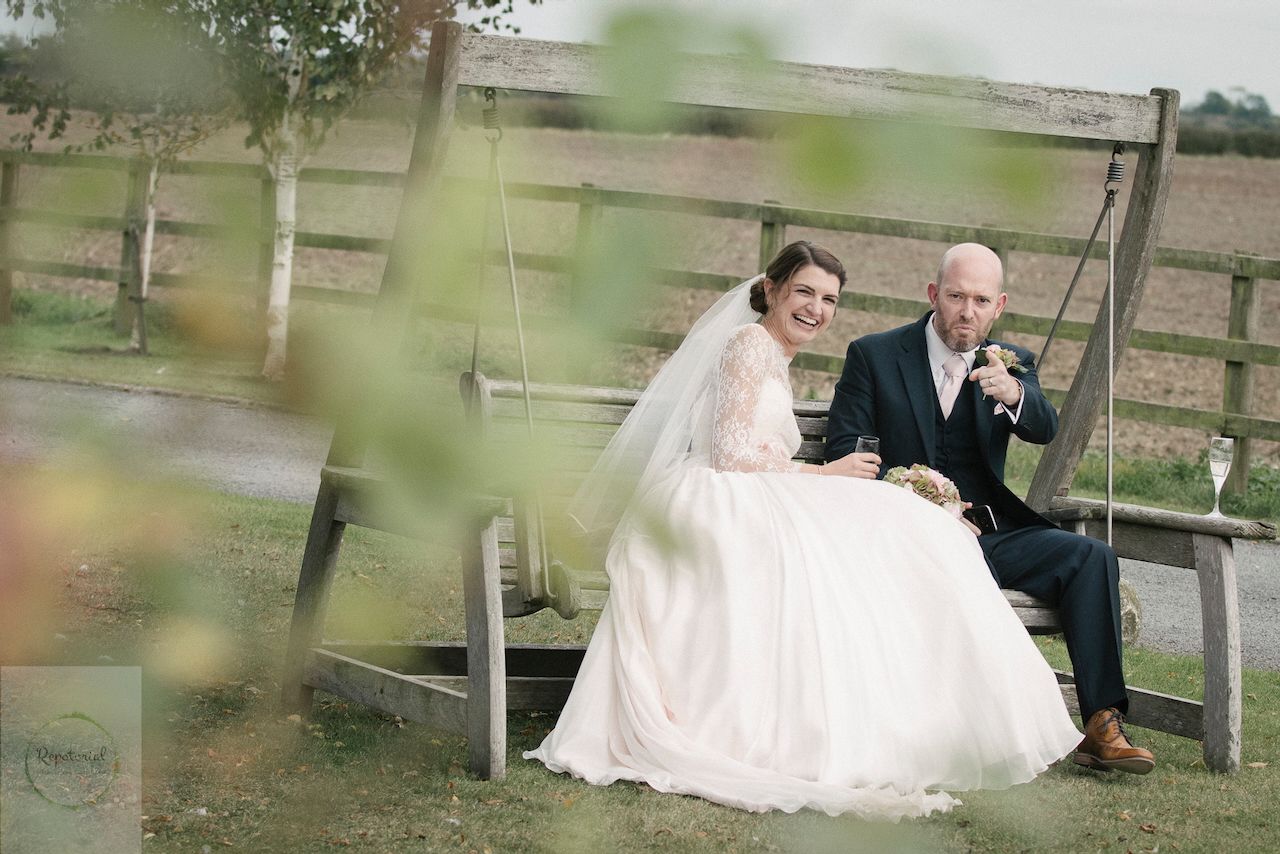 Bridge and groom enjoying the wedding reception captured in candid style. Stratton Court Barn