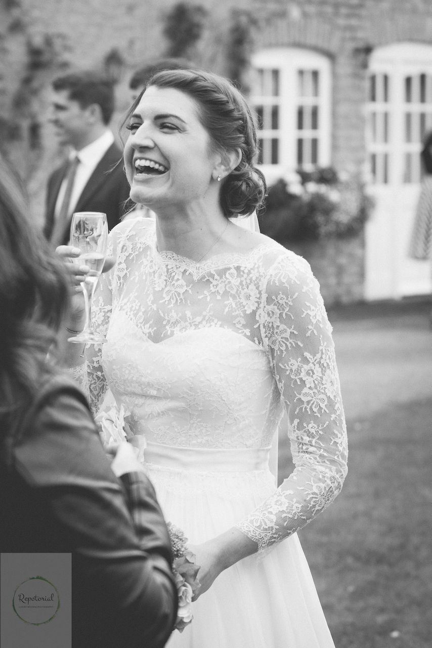 Editorial bridal portrait of a bride in black and white enjoying the wedding reception. Stratton Court Barn