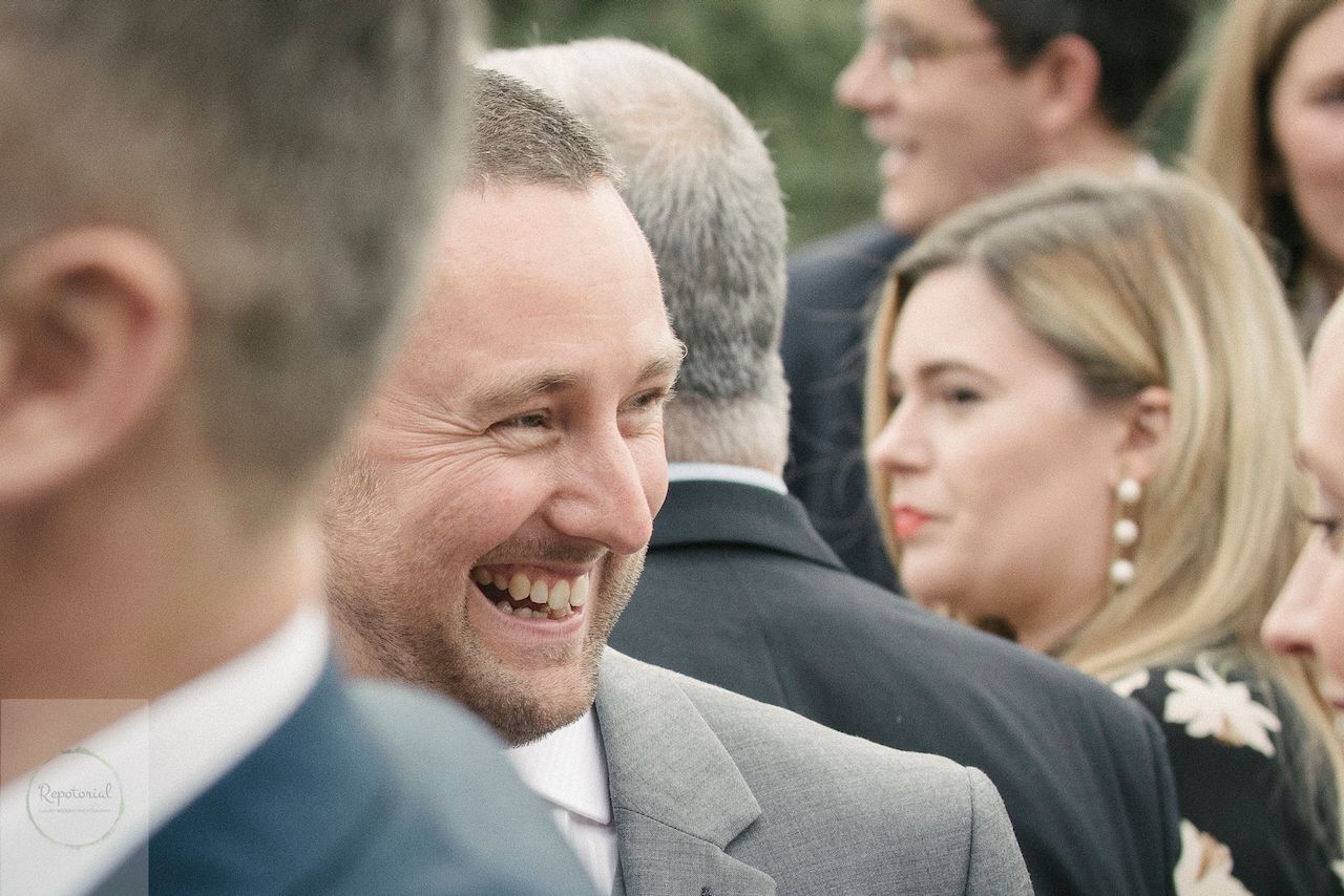 Guests enjoying the wedding reception captured in candid style. Stratton Court Barn