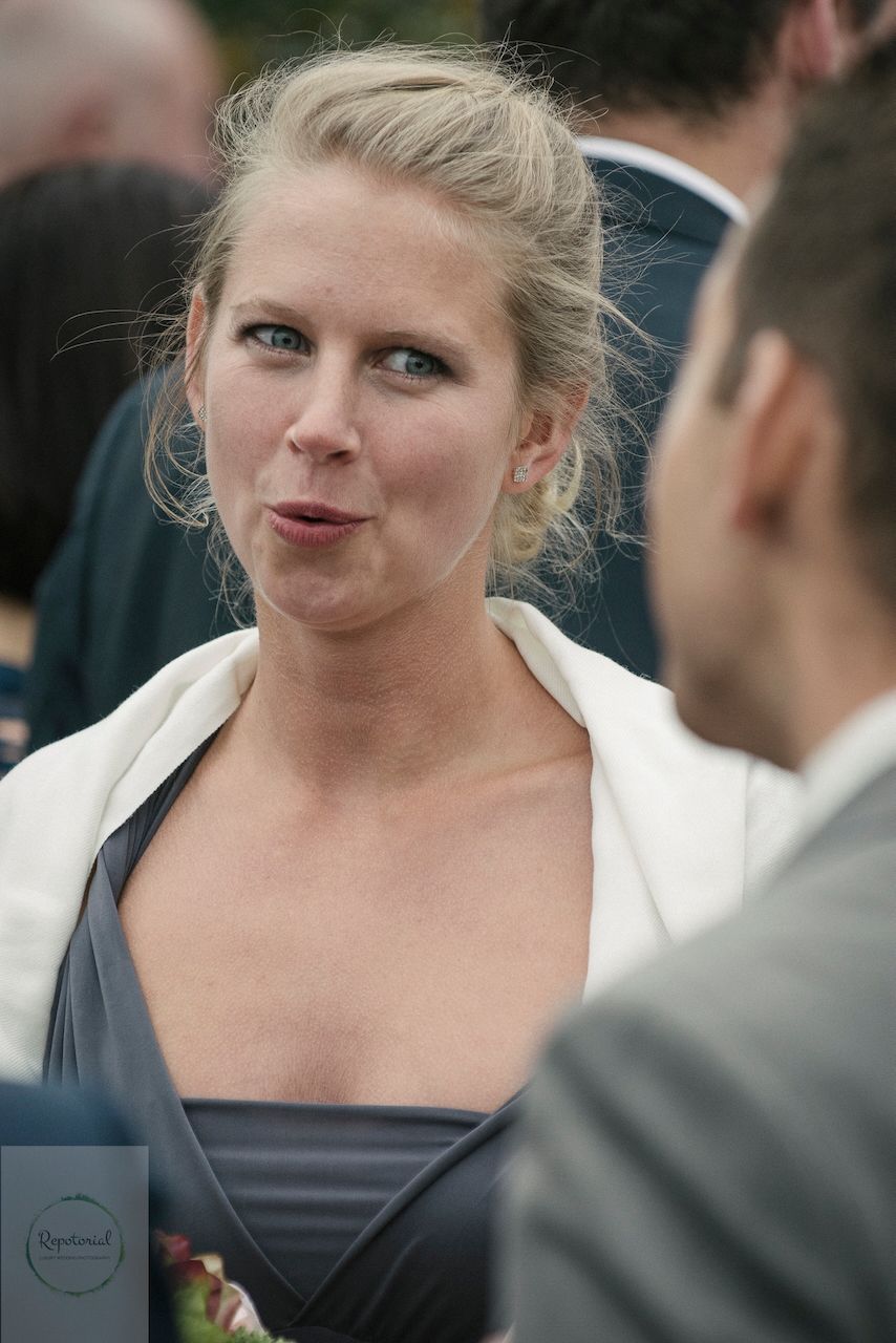 Guests enjoying the wedding reception captured in candid style. Stratton Court Barn