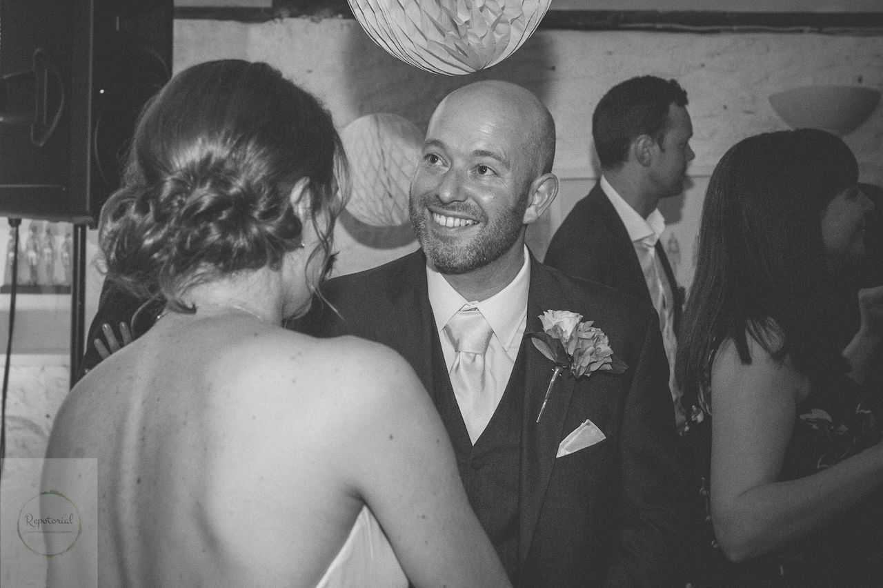 Editorial bridal portrait of a bride and groom in black and white enjoying the party. Stratton Court Barn