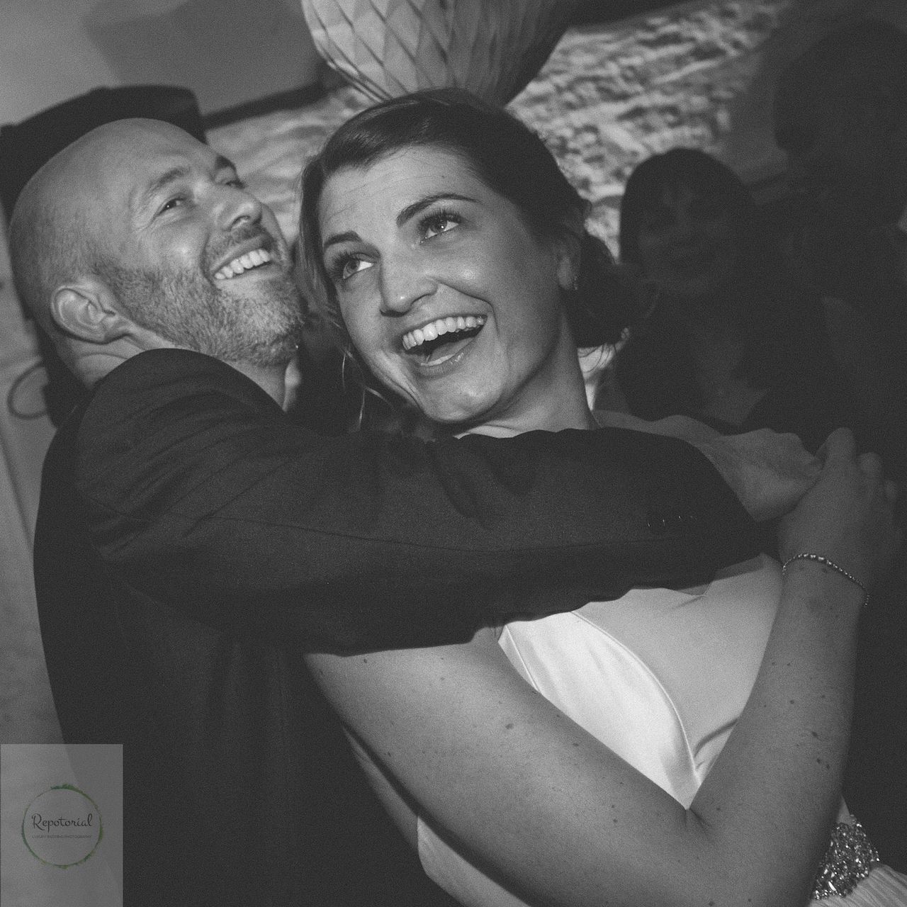 Editorial bridal portrait of a bride and groom in black and white enjoying the party. Stratton Court Barn