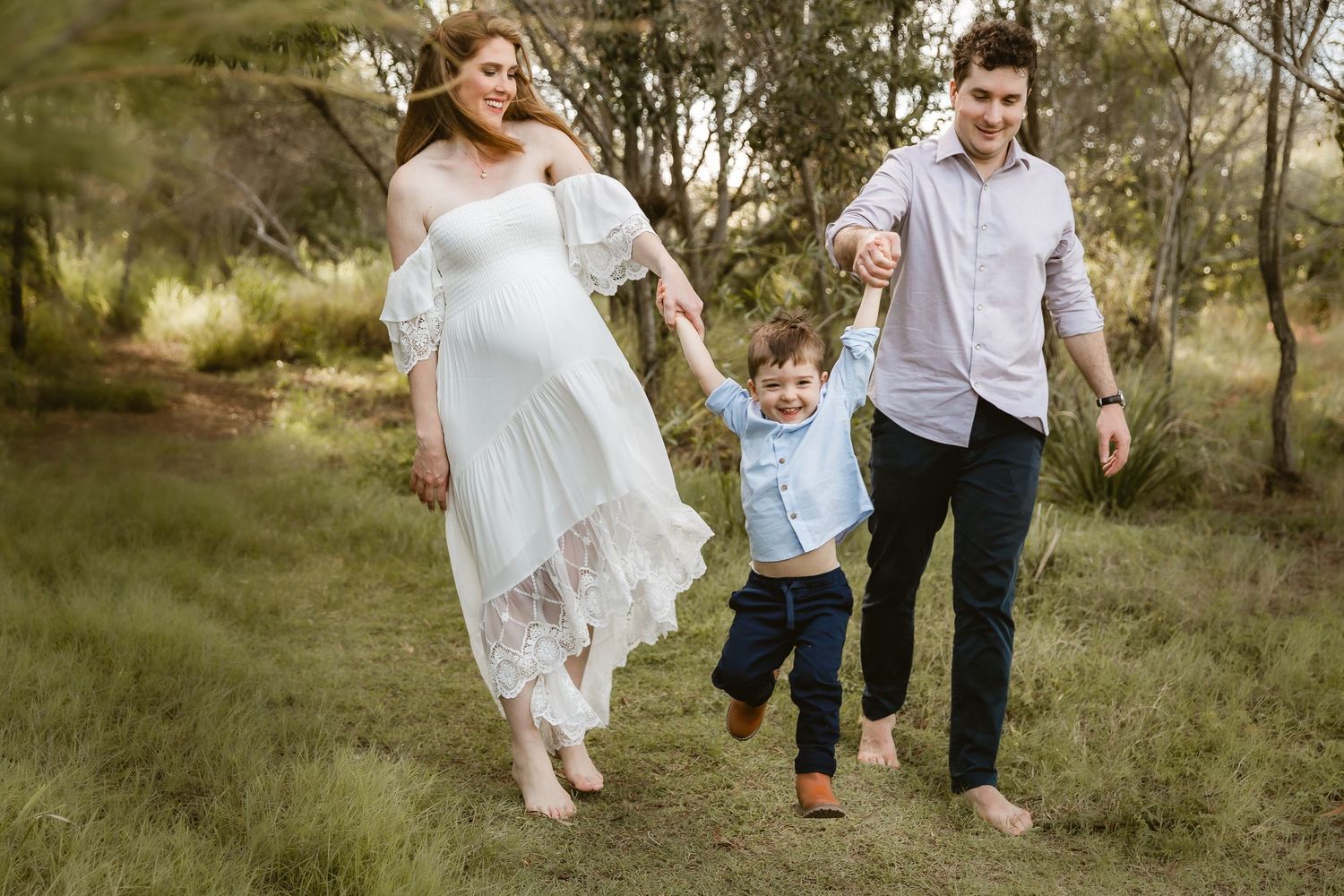 Couple having an intimate moment during a maternity shoot at Boondall Wetlands in Brisbane