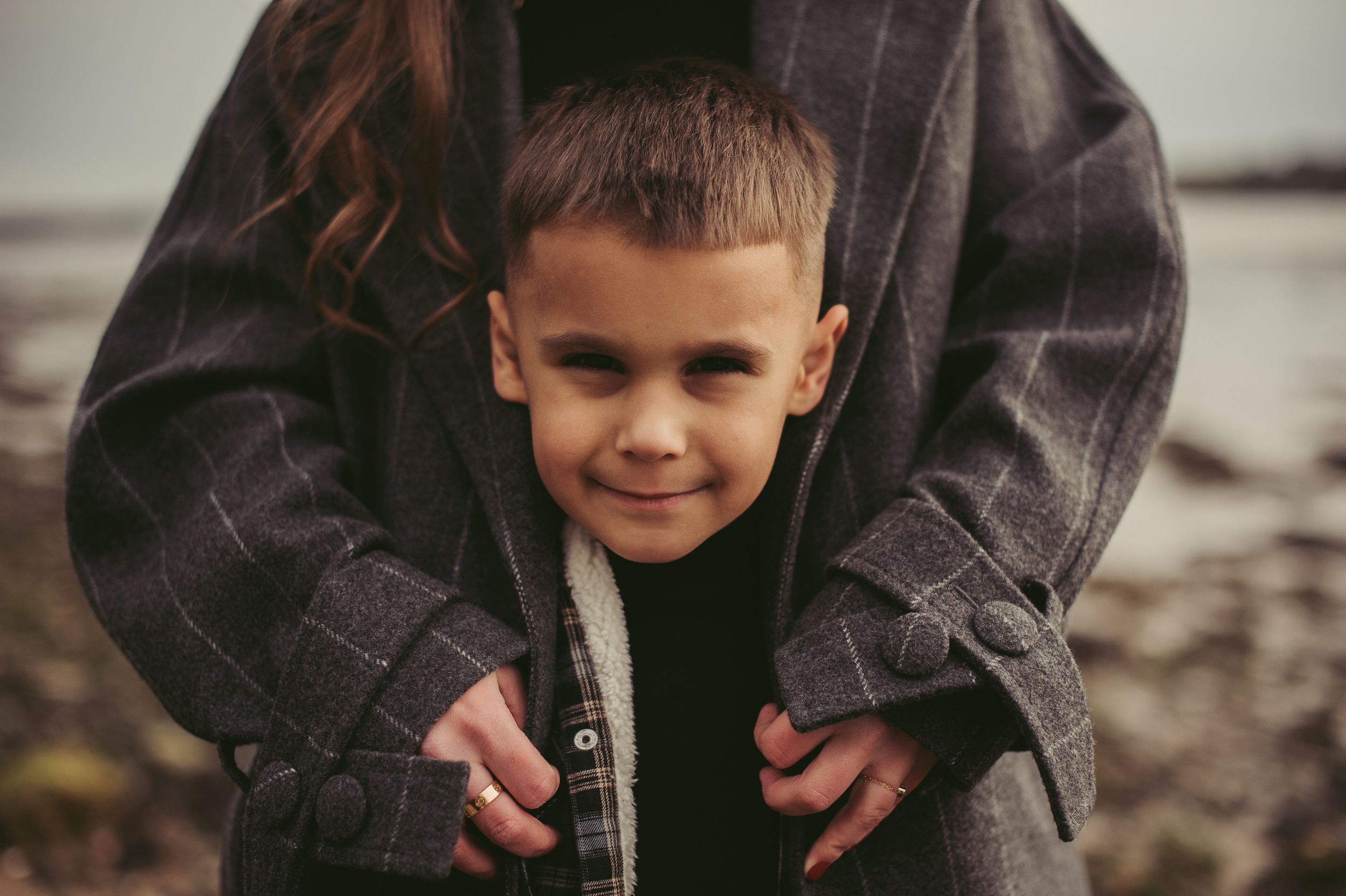 Lifestyle family image of a mother holding her son close