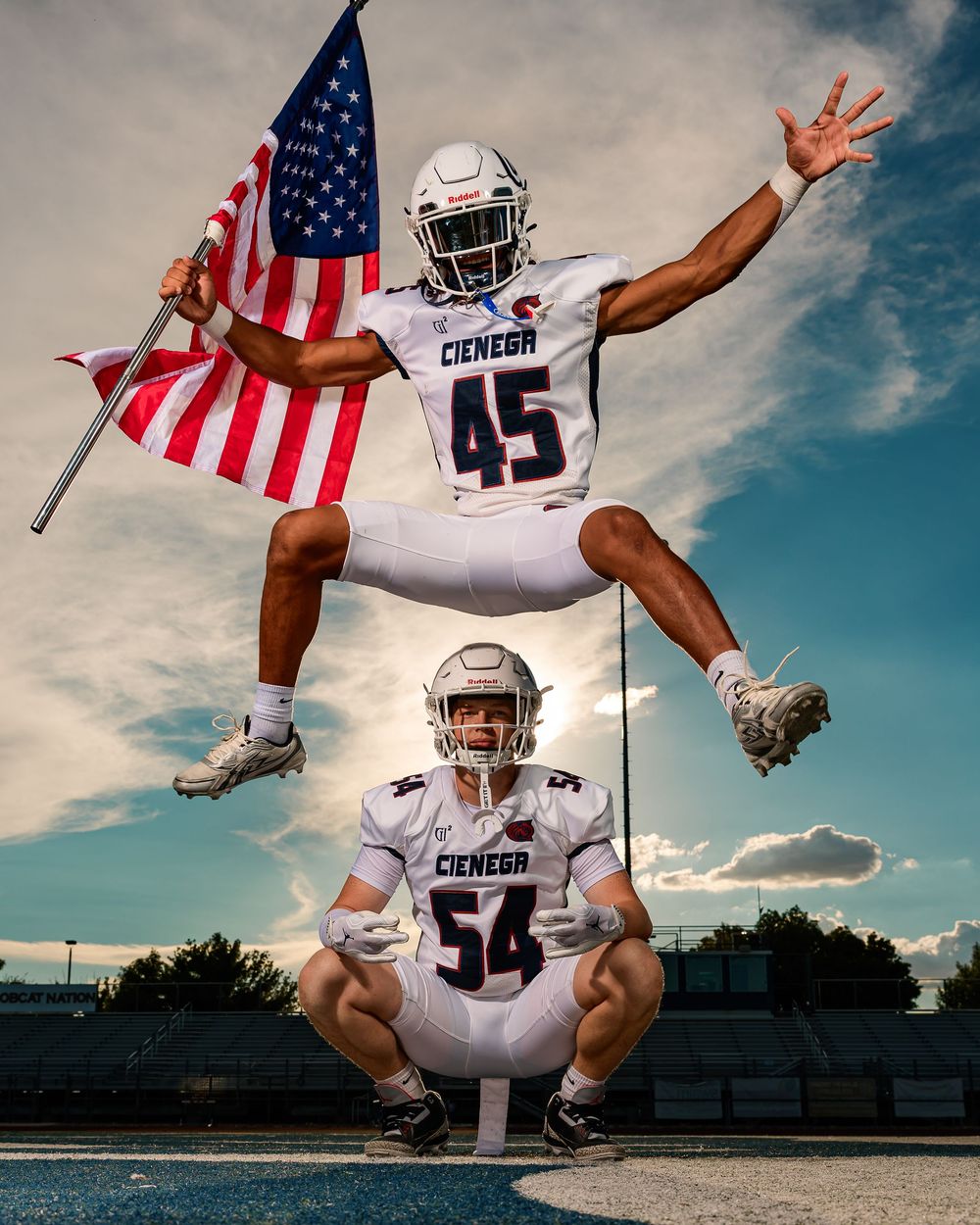Cienega senior football player jumping over other player with American Flag Tucson, AZ