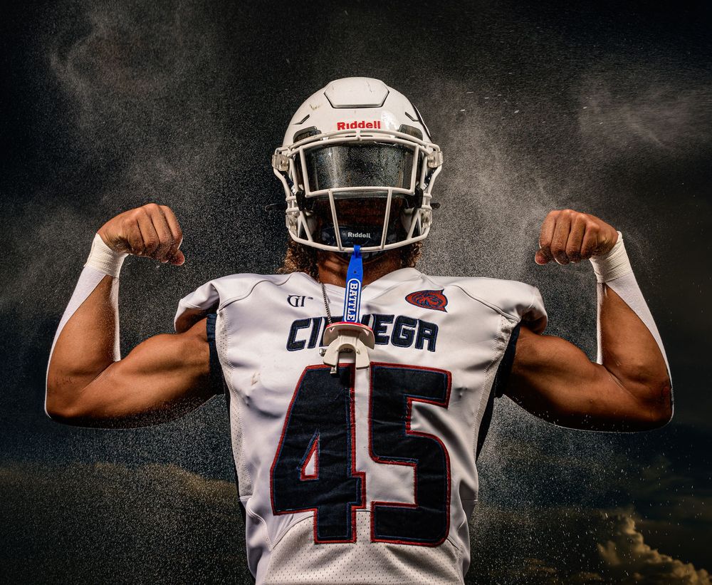 Cienega senior football player flexing muscles with water spray Tucson, AZ