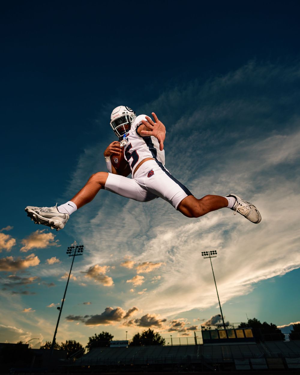 Cienega senior football player jumping in the sky with a football Tucson, AZ