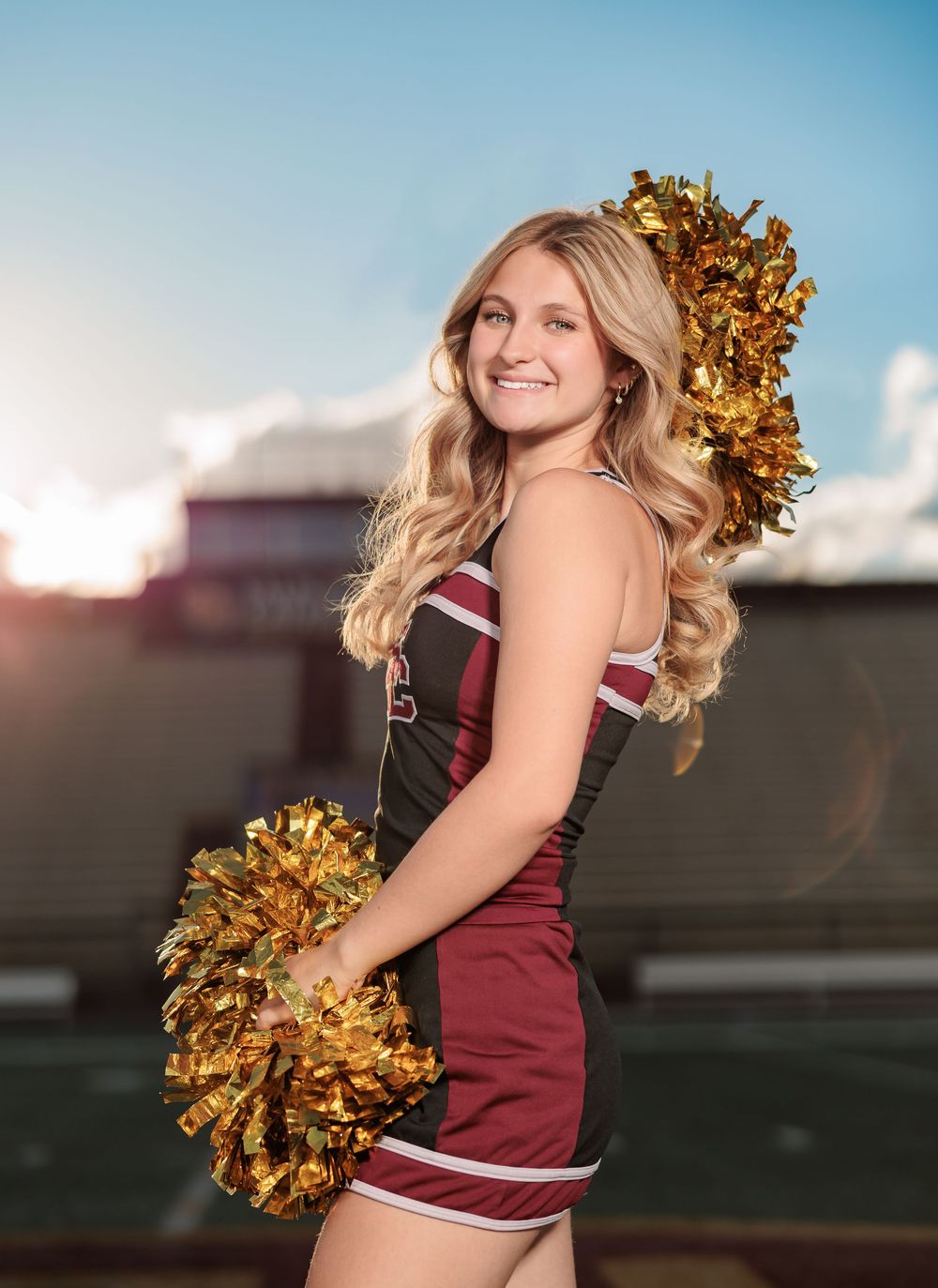 Salpointe High School Senior Cheerleader posing in uniform with poms on football field Tucson, AZ