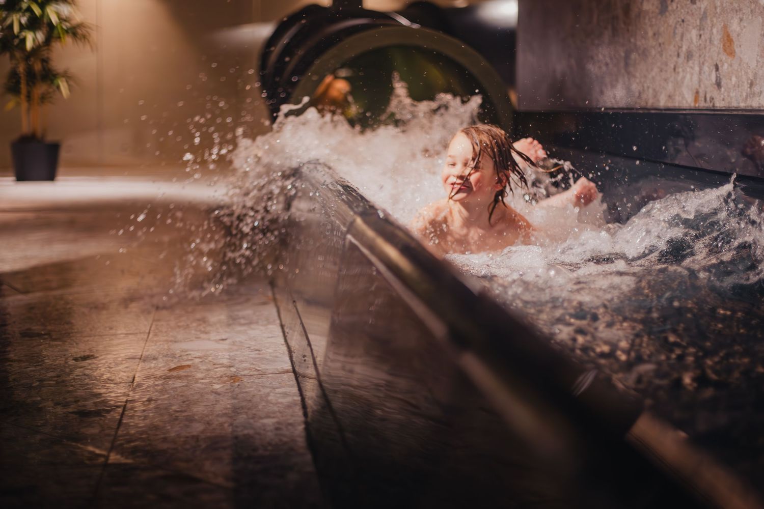 Dramatic splash of water in a jacuzzi or hot tub with dynamic motion captured against dark background.