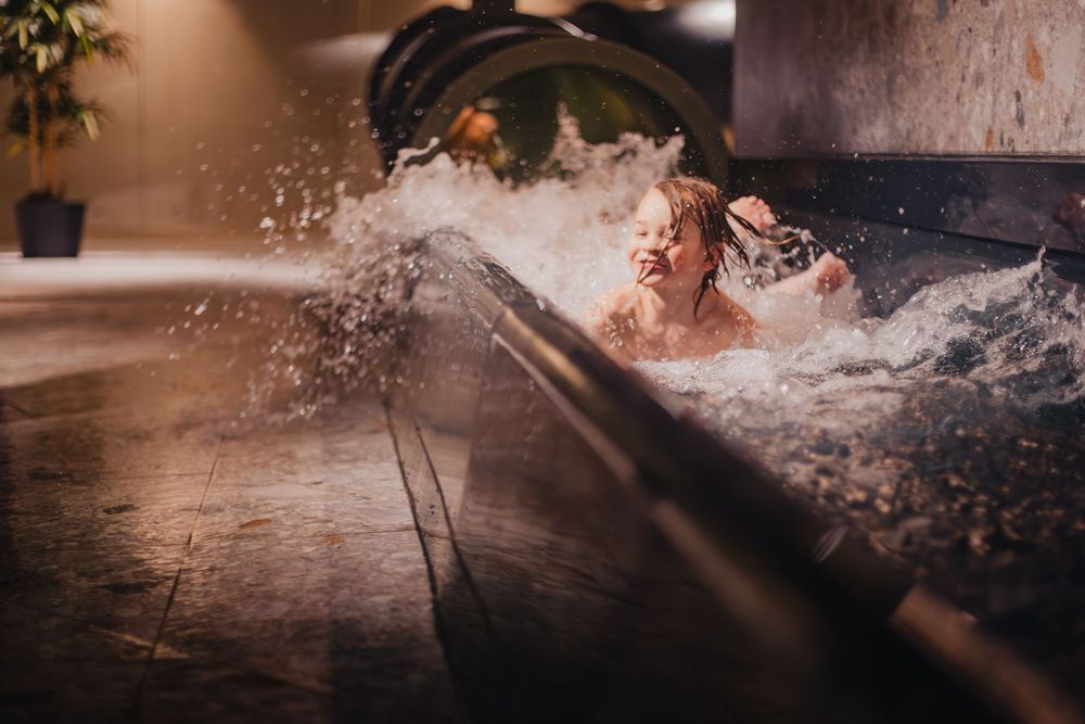 Dramatic splash of water in a jacuzzi or hot tub with dynamic motion captured against dark background.