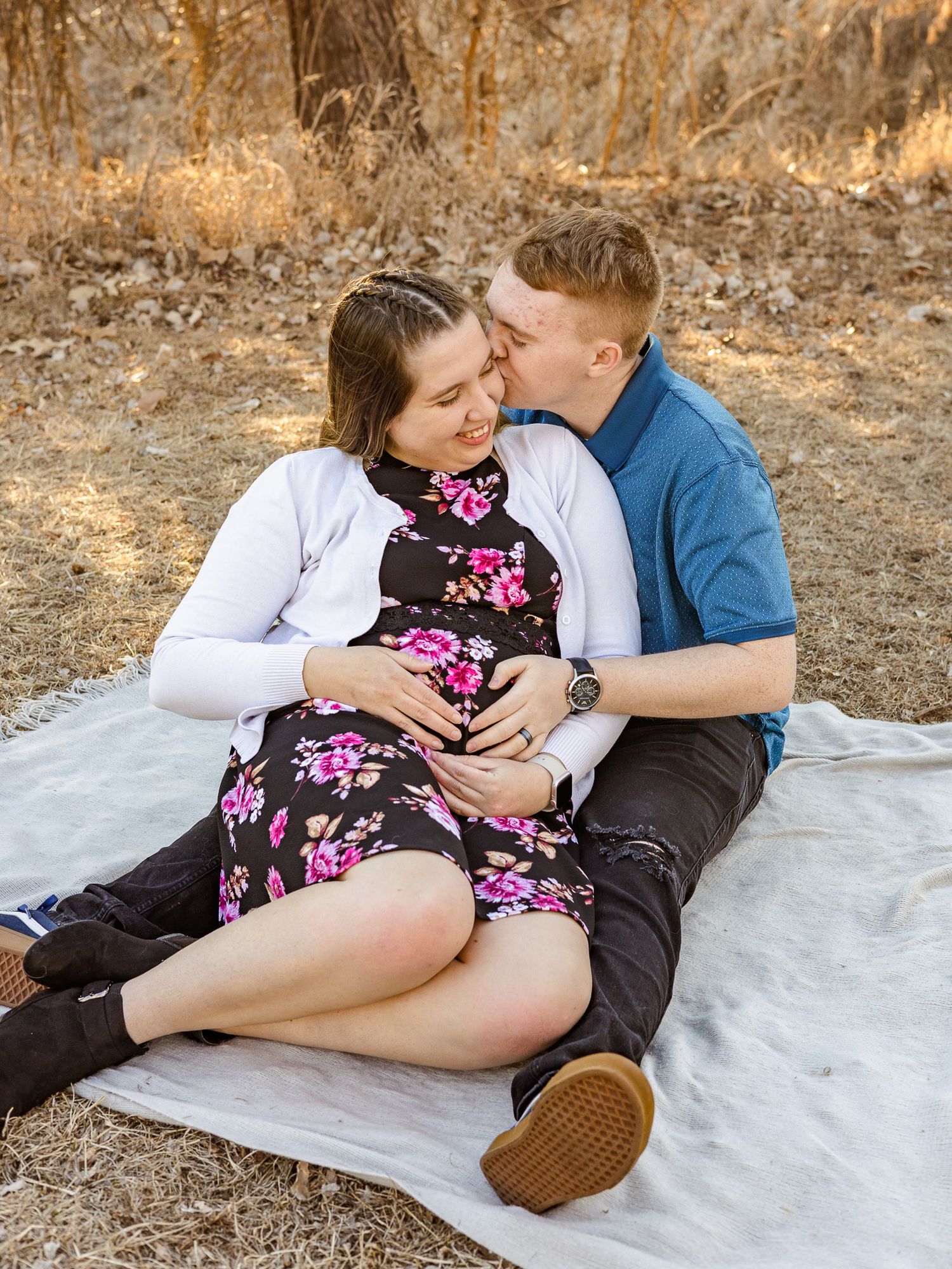 Picture of married couple doing a gender reveal celebrating that they are having a baby boy