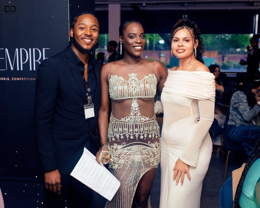Formal evening event with people wearing elegant gowns and attire.