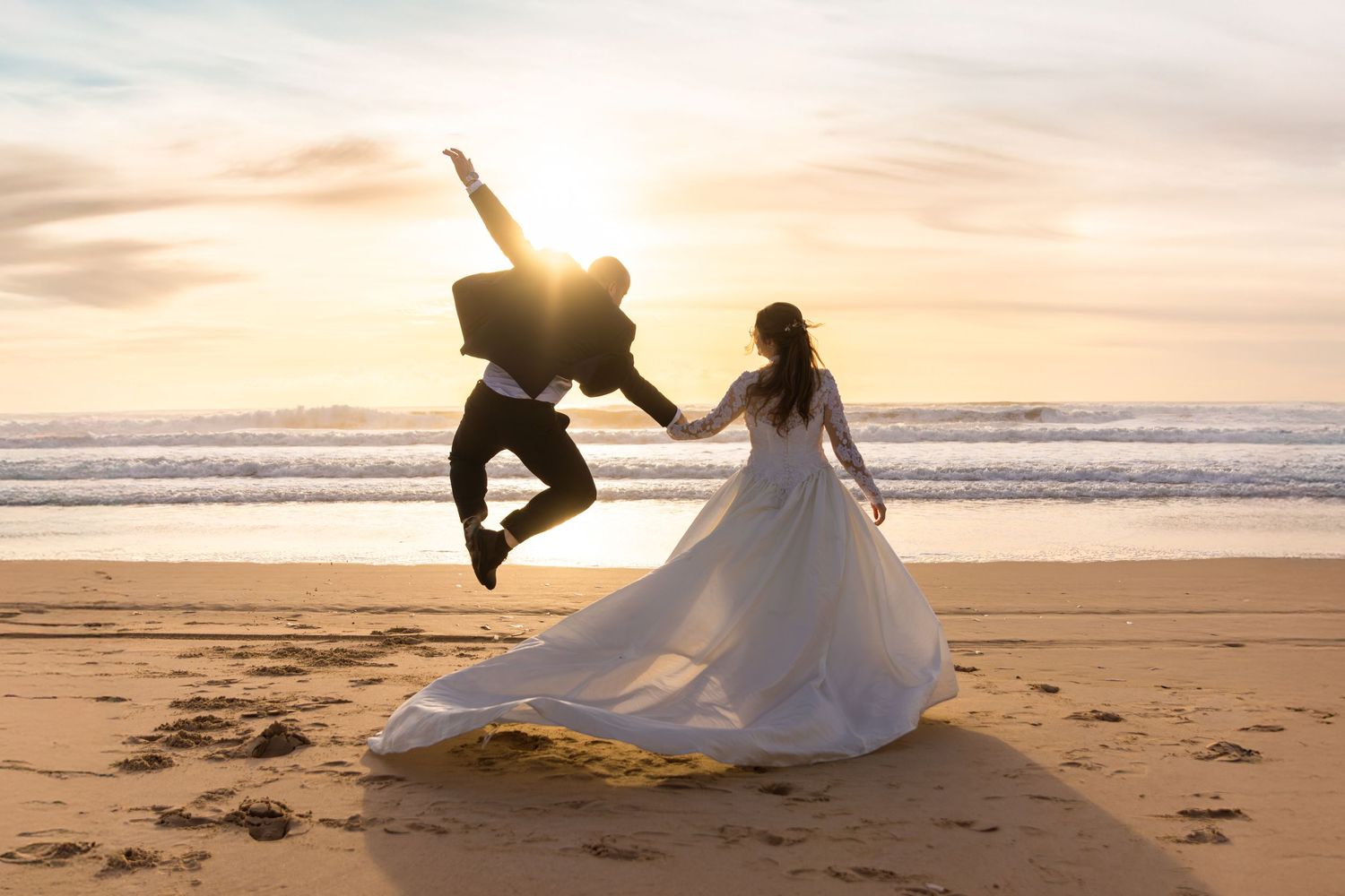 Romantic beach wedding photoshoot at golden sunset.