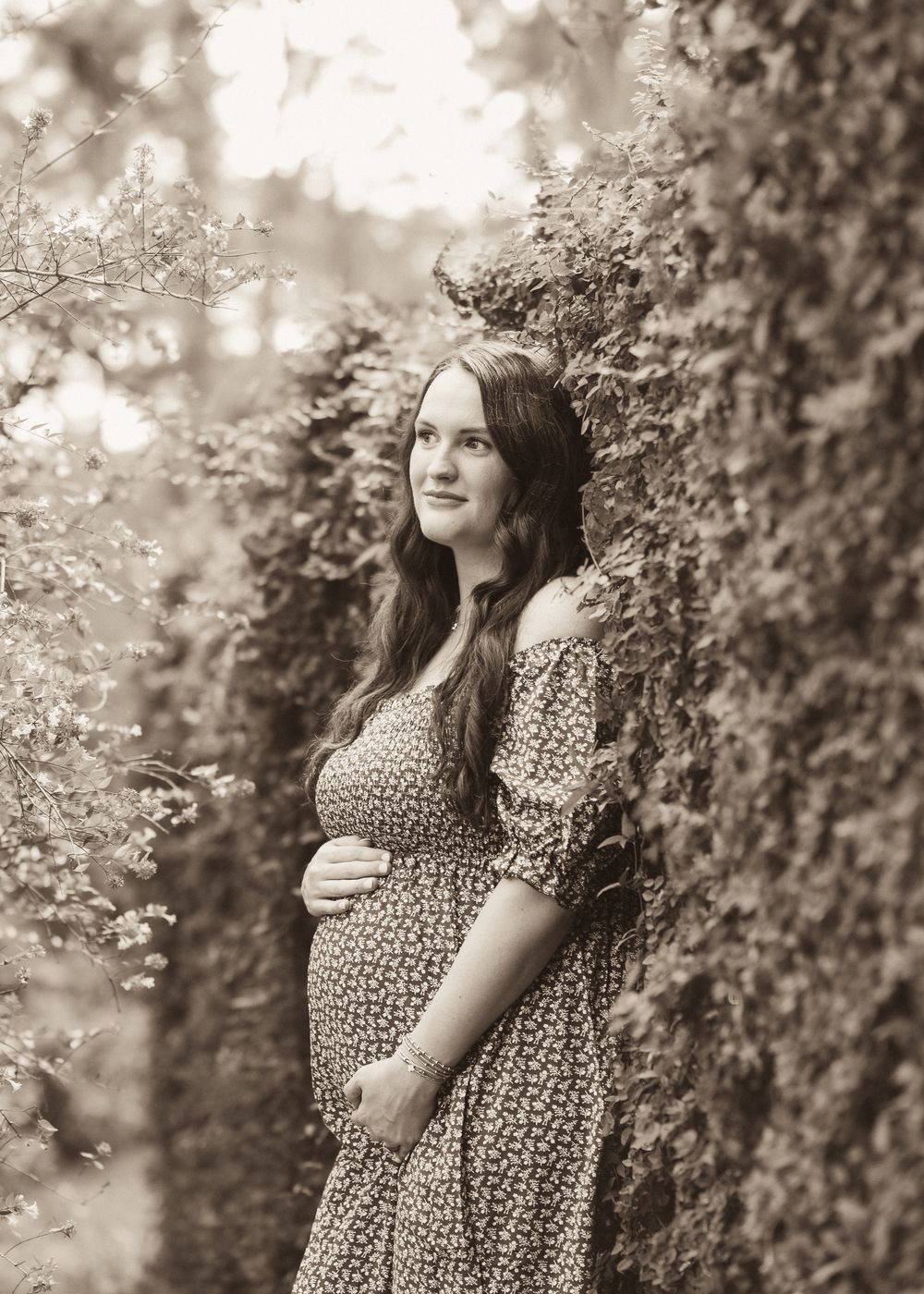 A series of vintage-style monochrome photos showing someone in a polka dot dress posing against an ivy-covered wall outdoors.