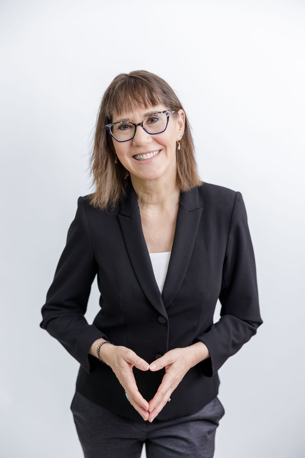 woman business owner life binge drinking coach and author headshot branding in Bonney Lake, WA wearing blazer standing on white backdrop
