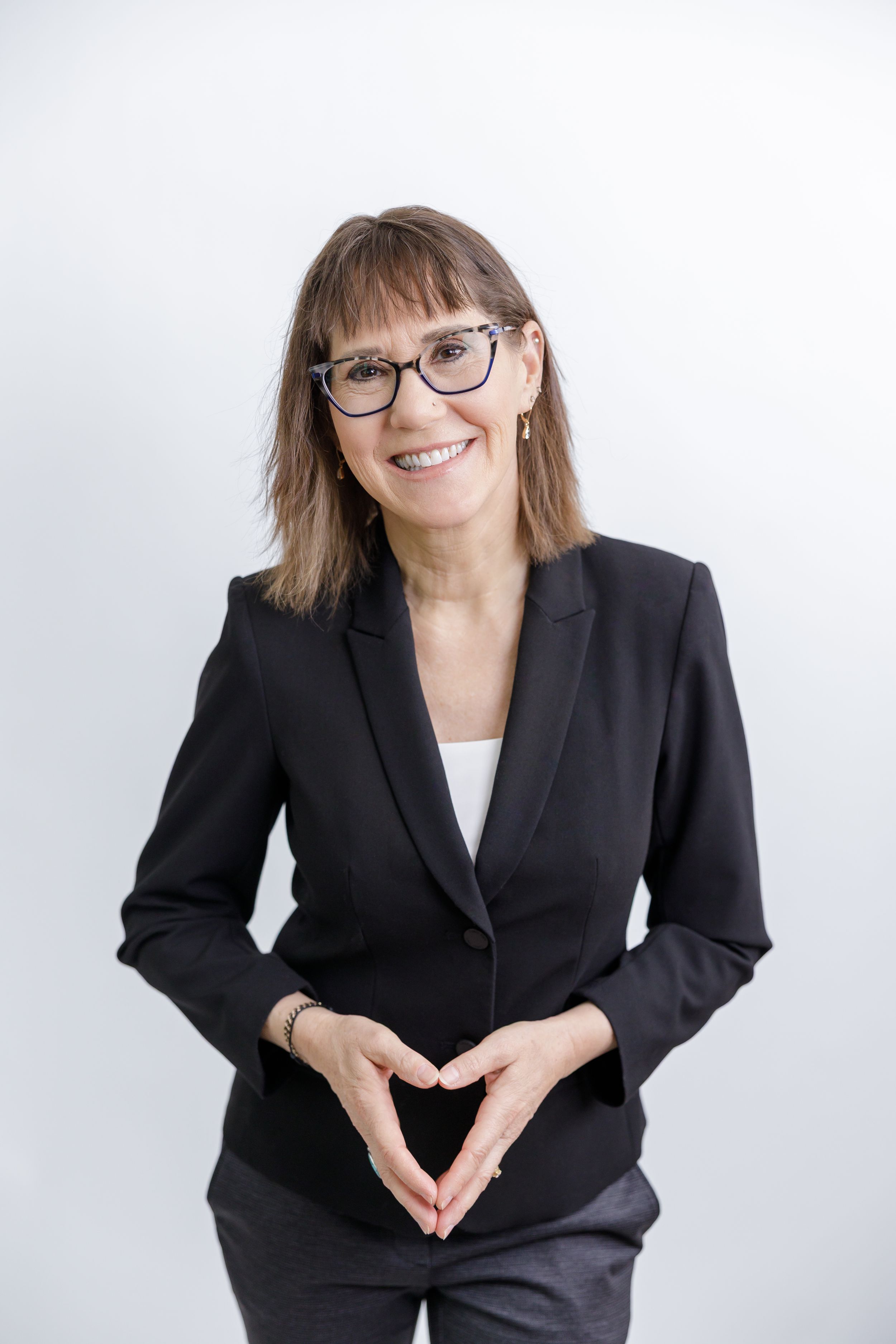 woman business owner life binge drinking coach and author headshot branding in Bonney Lake, WA wearing blazer standing on white backdrop