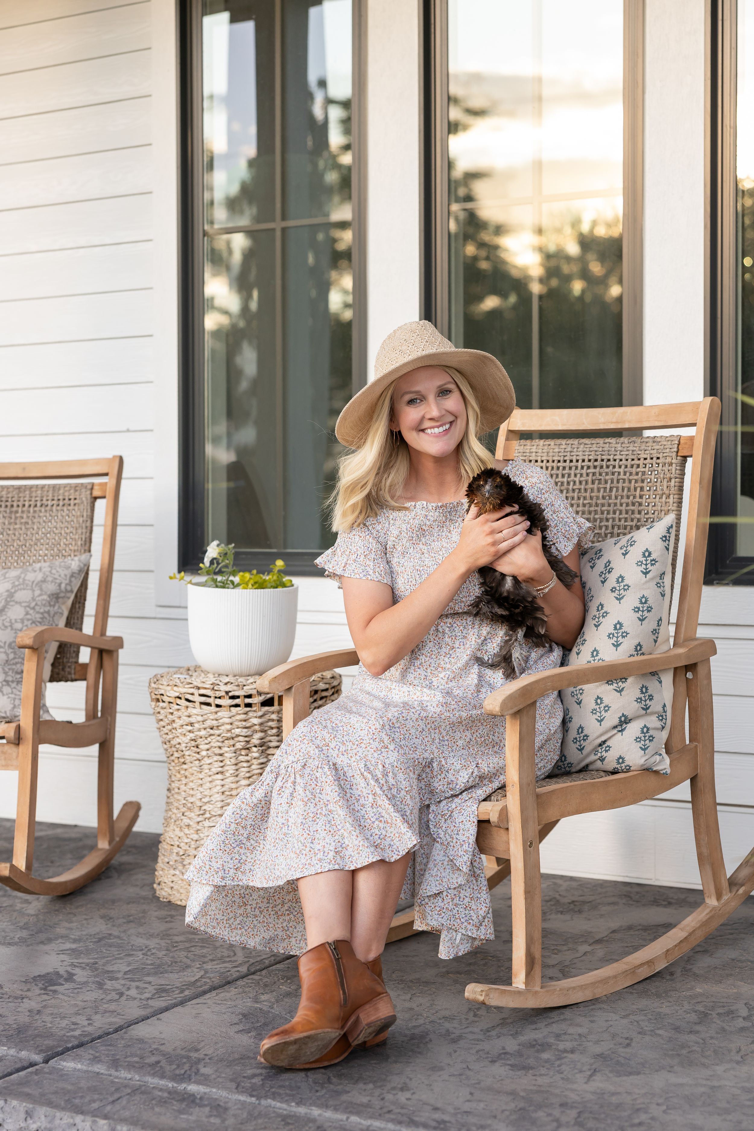 Jamie williams interior design in Walla Walla, WA lifestyle branding headshot sitting on porch rocking chair holding chicken at golden hour