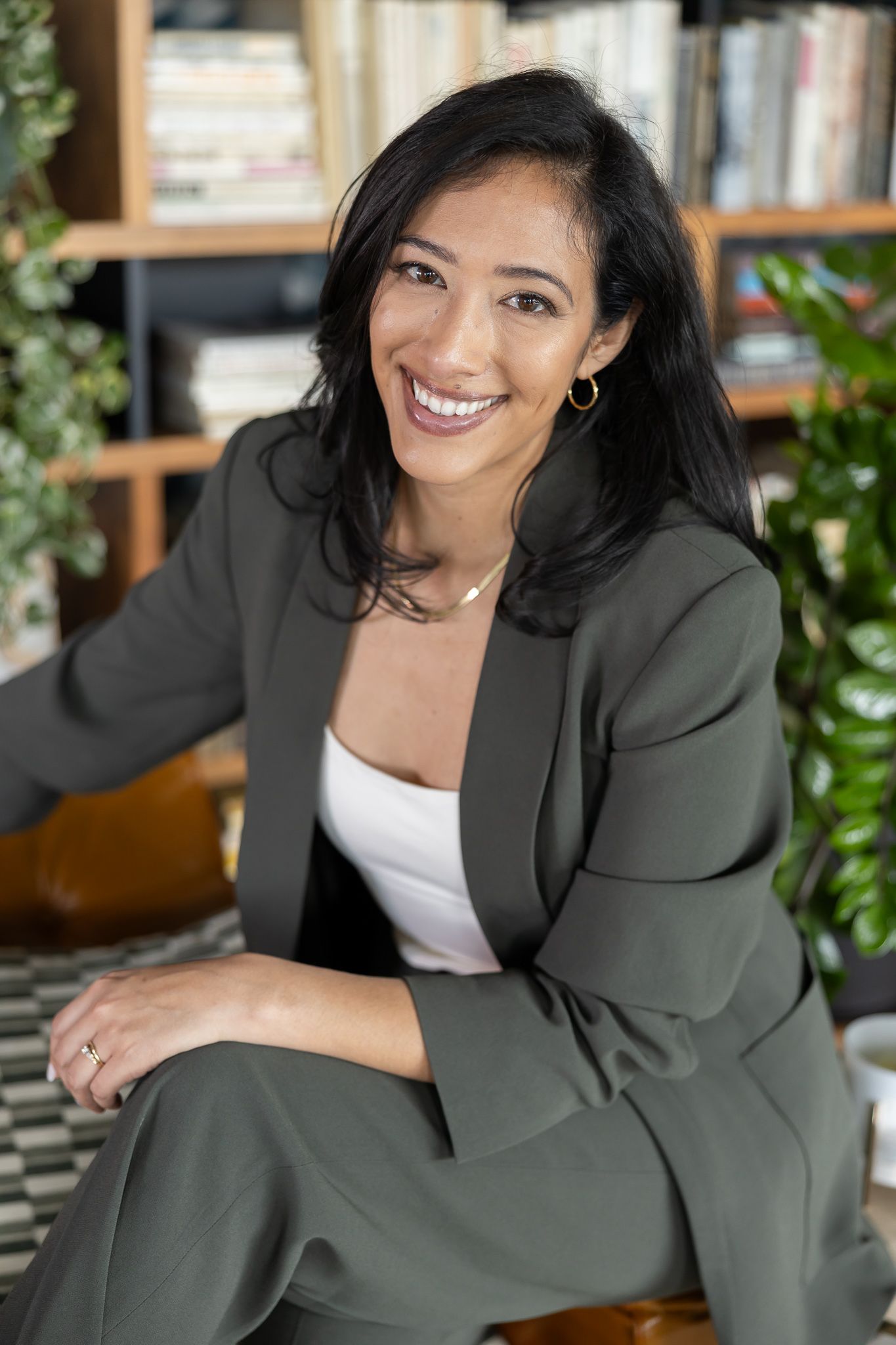Latina salary negotiator coach for woman money mindset business owner in Seattle, WA sitting on chair for lifestyle headshot