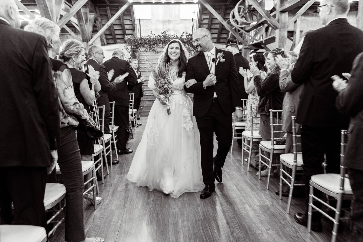 Black and white photos capture emotional moments during indoor wedding ceremony.