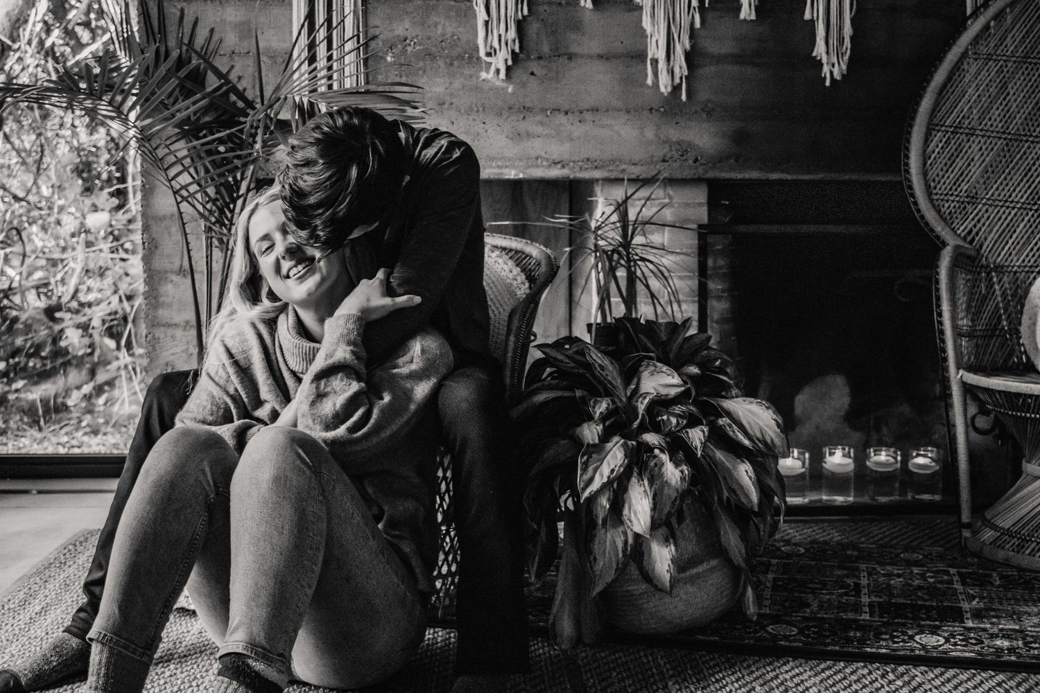 Couple curled up cuddling in a cabin for their adventure engagement session in Tofino, British Columbia