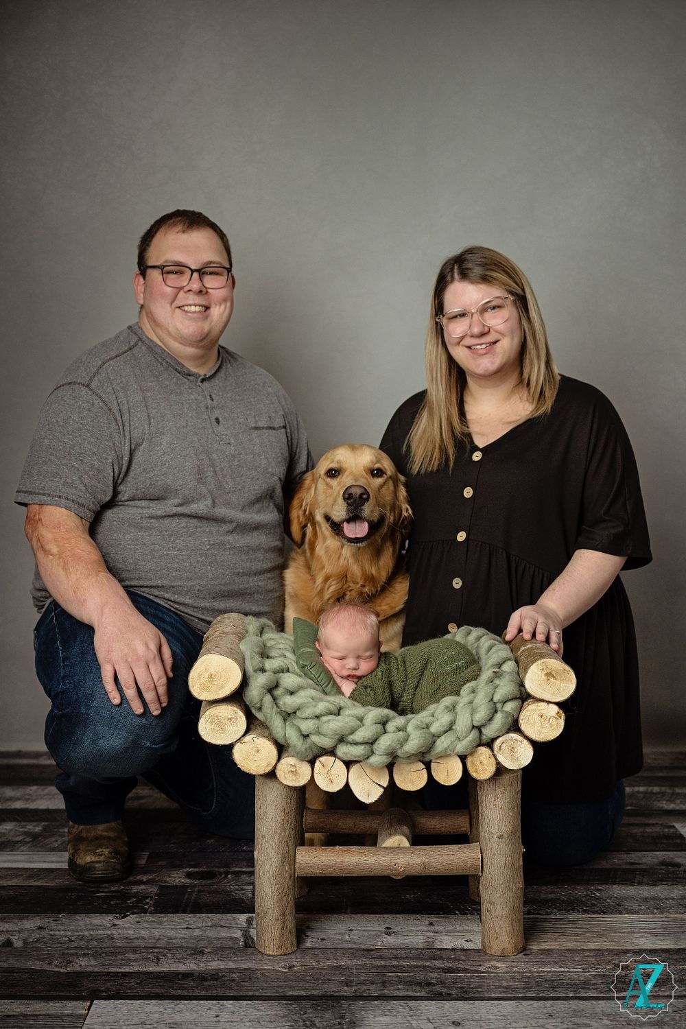 Family portrait with golden retriever and rustic wooden bench with green knit decor.