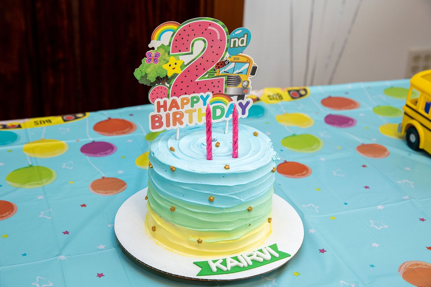 Birthday cake with number 2 topper decorated in blue ombre frosting.