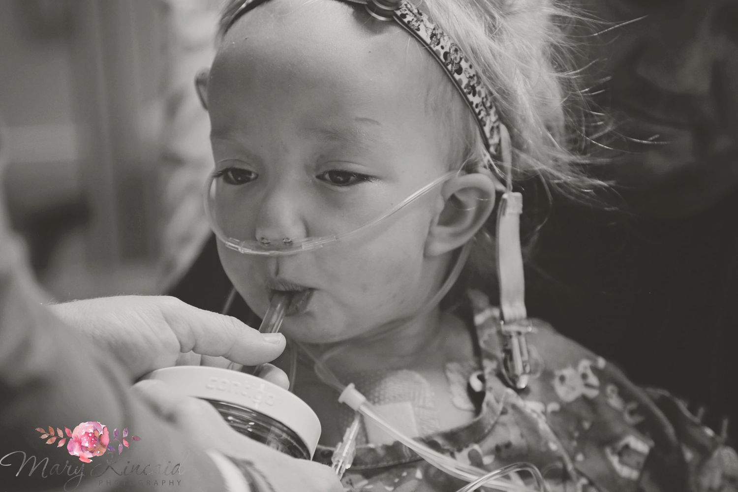Hospital Photo of heart warrior taking first drink after heart surgery.