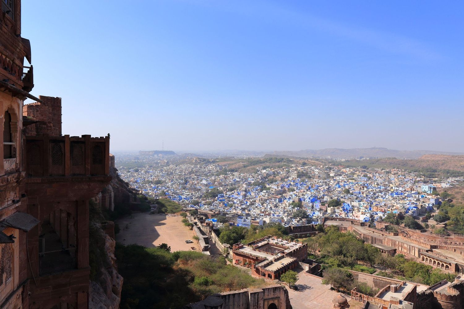 Panoramic cityscape view of Jodhpur's blue buildings from elevated fortress position.