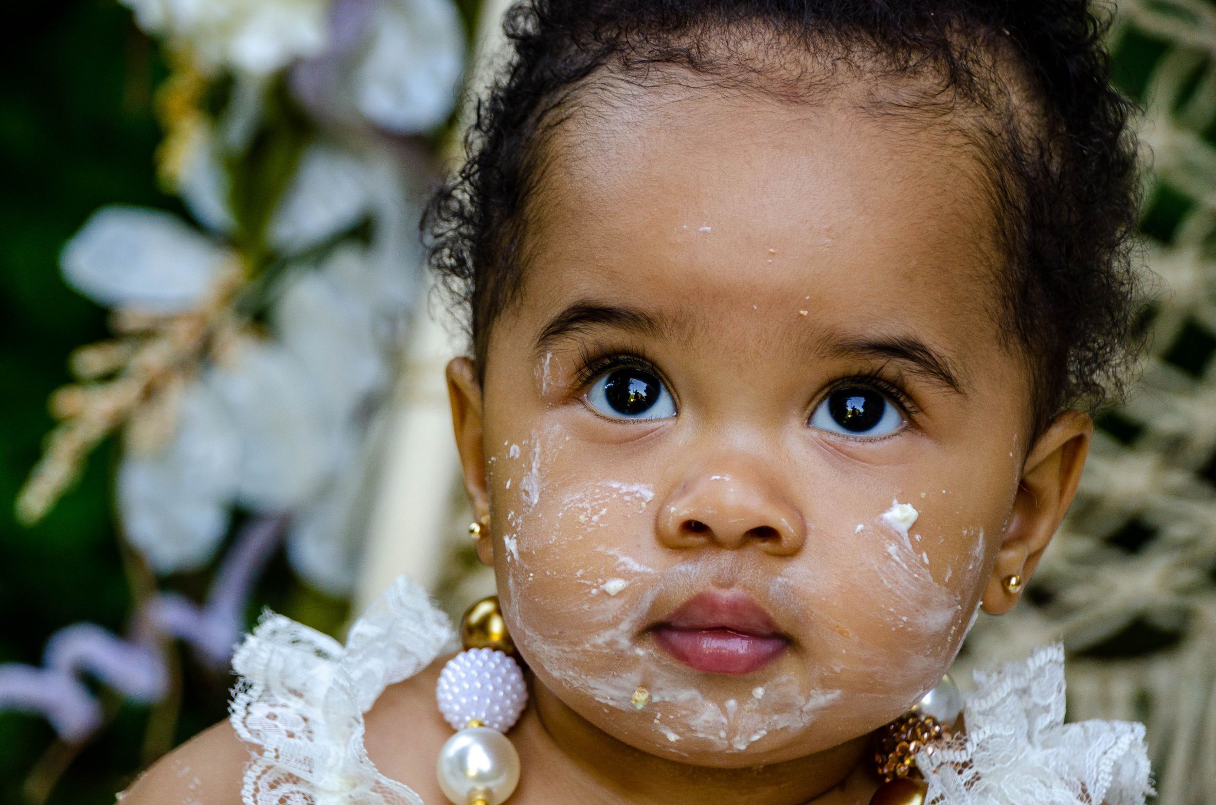 Adorable baby captured in a soft, natural moment during a newborn or infant photo session.