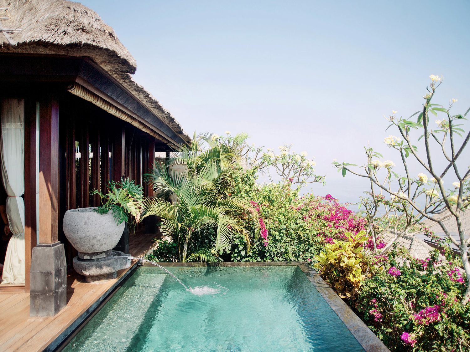 Serene pool with ocean vistas and vibrant foliage, offering an idyllic setting for a wedding at Bulgari Resort Bali.