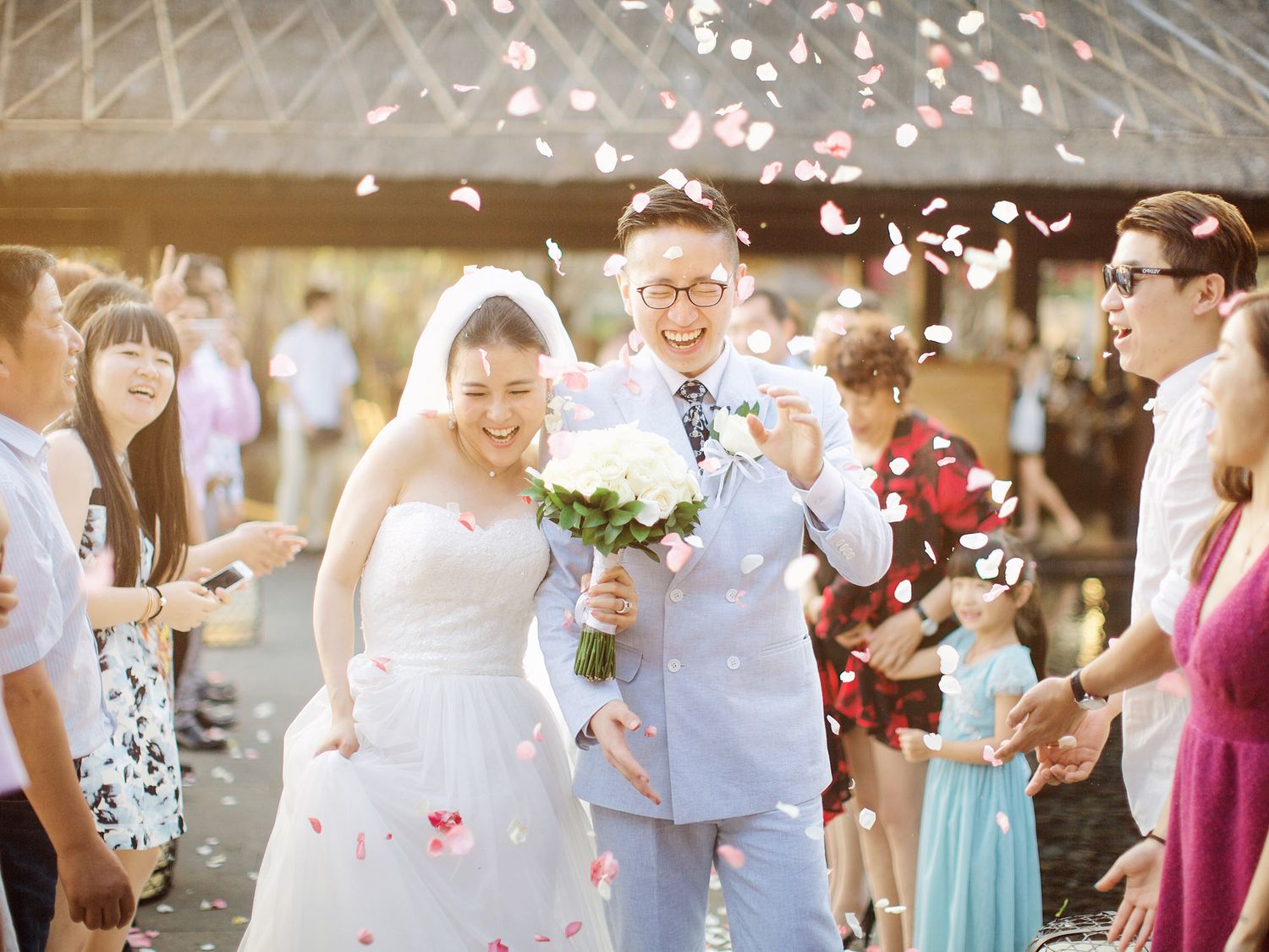 A couple exiting their wedding ceremony at Bulgari Resort Bali.