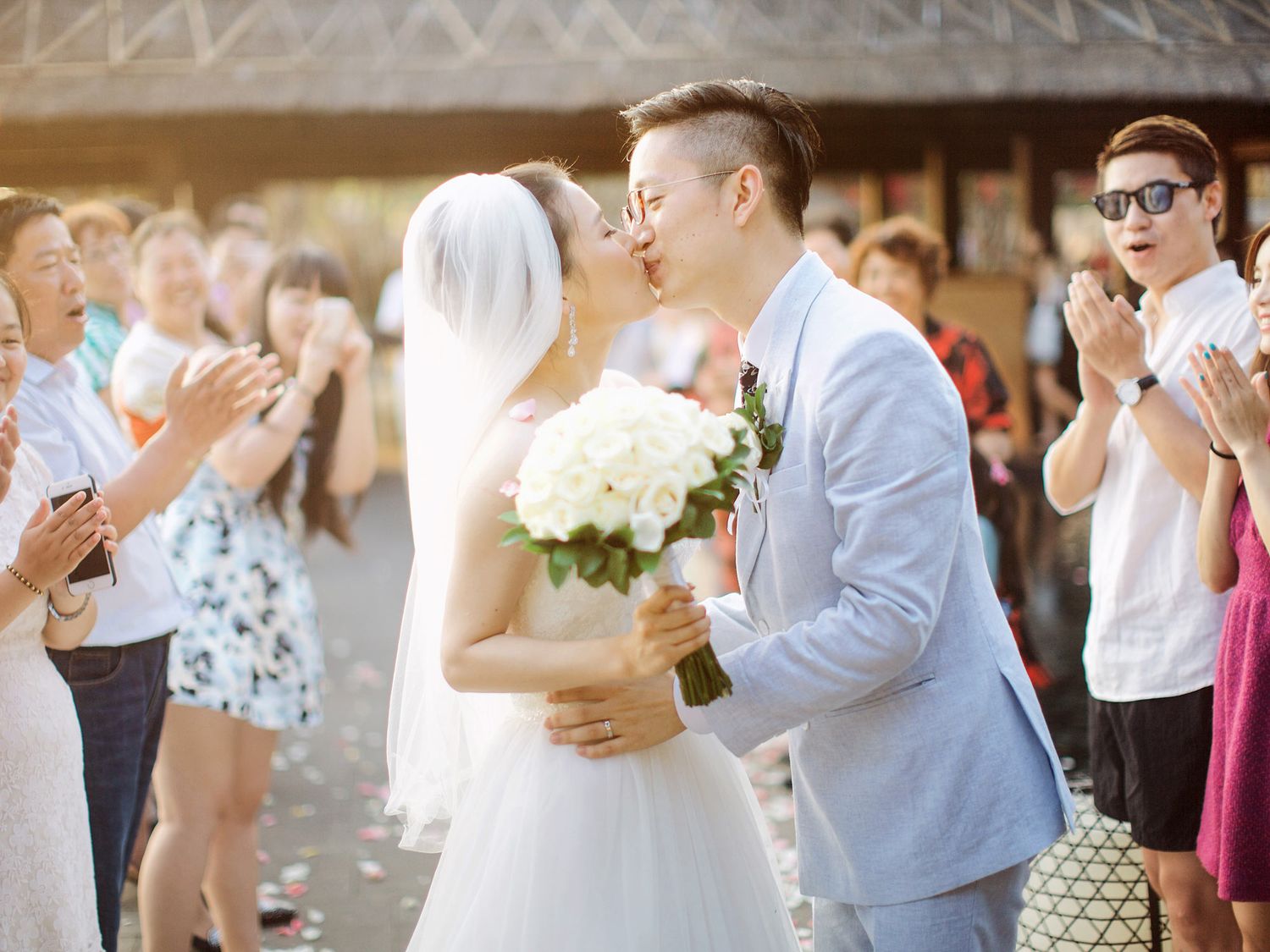Newlyweds sharing a romantic kiss during their wedding ceremony at Bulgari Resort Bali.