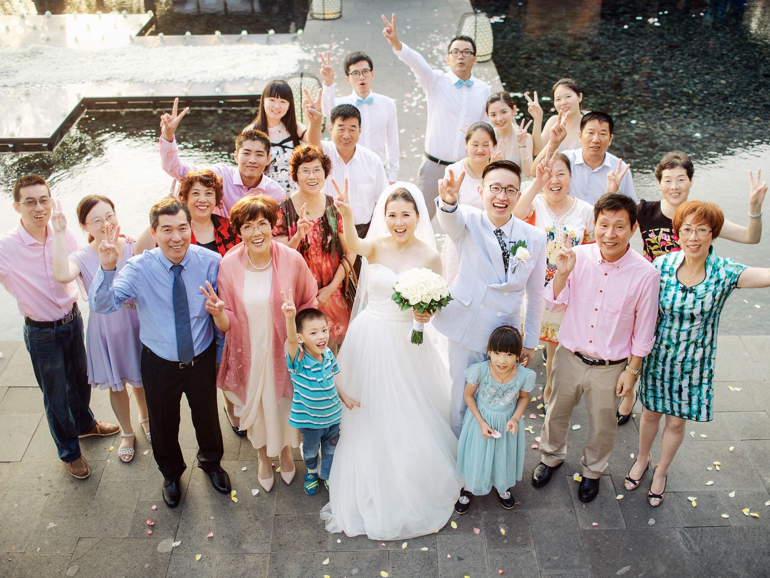 A wedding group photo at Bulgari Resort Bali featuring people in elegant wedding attire.