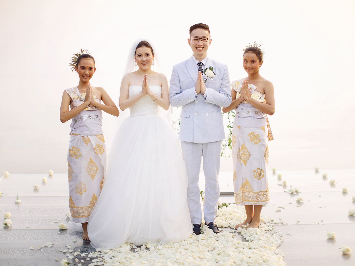 Wedding group posing in front of Bulgari Resort Bali, surrounded by stunning ocean backdrop.