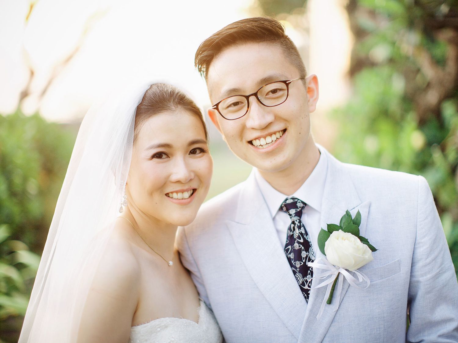 A bride and groom smiling, standing close together, posing for a photo at Bulgari Resort Bali.