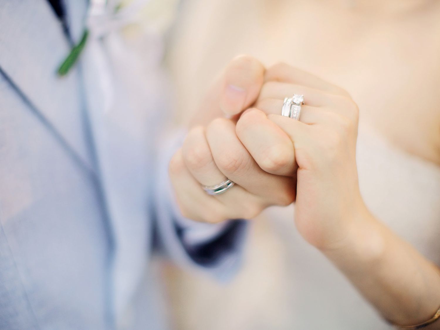 Close up of couple's hands with luxury wedding ring at Bulgari Resort Bali.