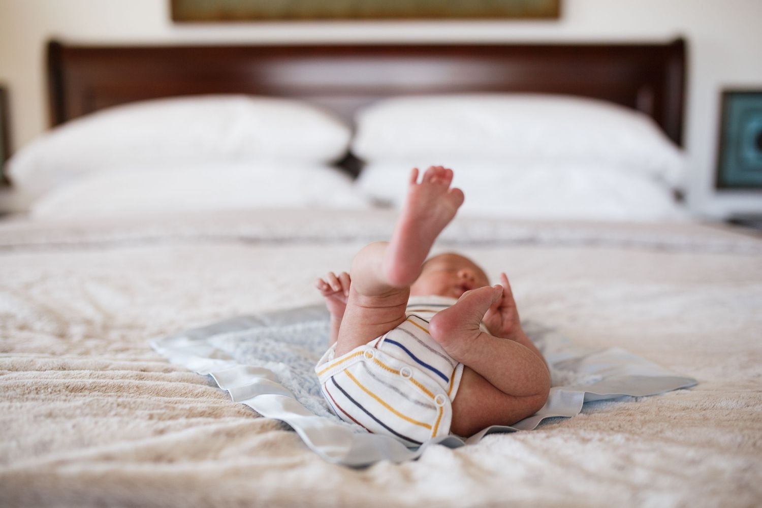 mukilteo newborn photography: a newborn baby with his feet in the air at an in-home newborn session