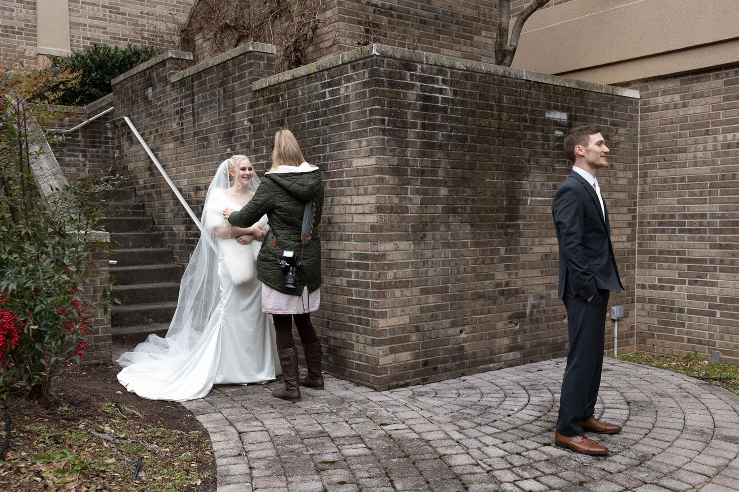 Wedding photo session near brick wall with stone steps and pathways.