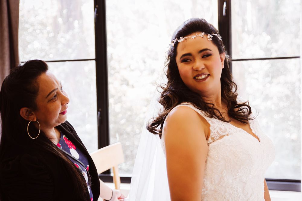 Wedding party celebrating in an indoor venue with natural lighting.