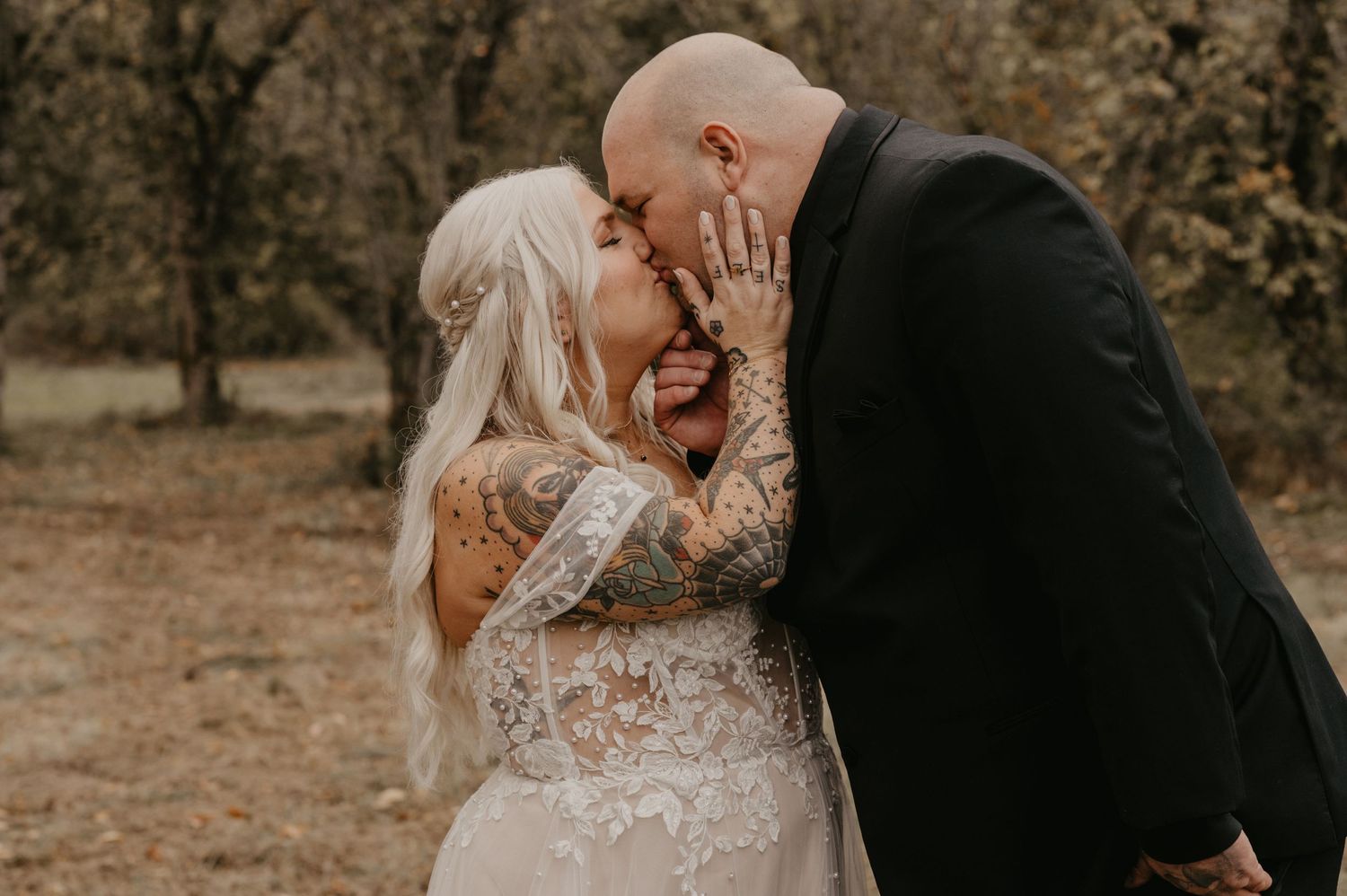 Intimate moment between newlyweds sharing laughter during outdoor wedding photo session.