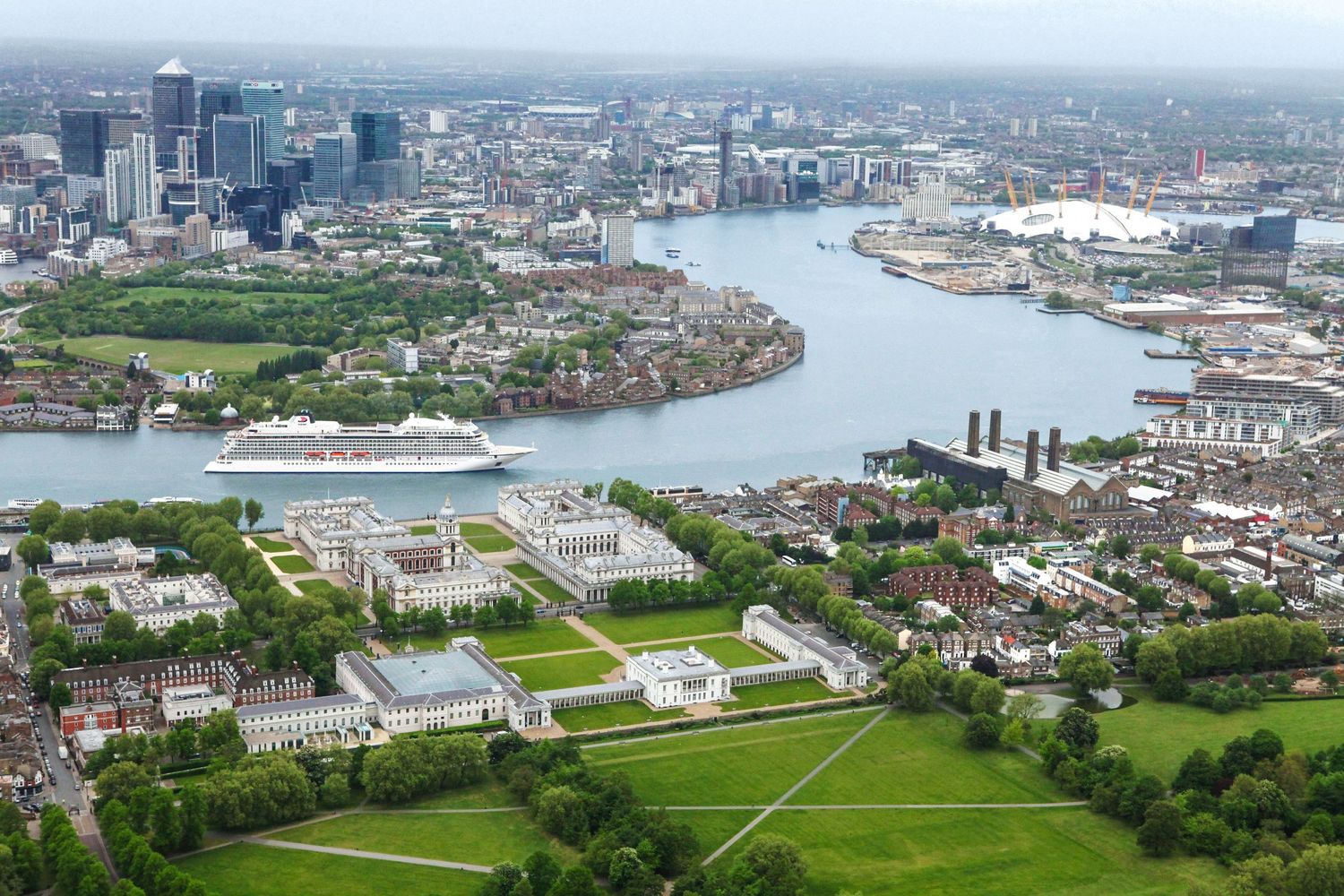 Aerial view of Greenwich Maritime district in London showing the River Thames winding through urban landscape.