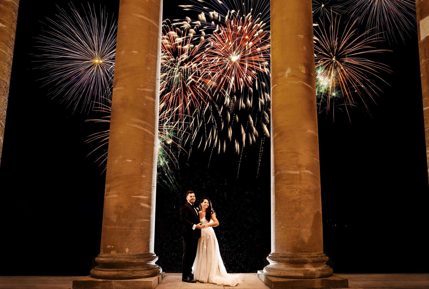 Bride and Groom at historic Stowe House in Buckingham with firework display behind them