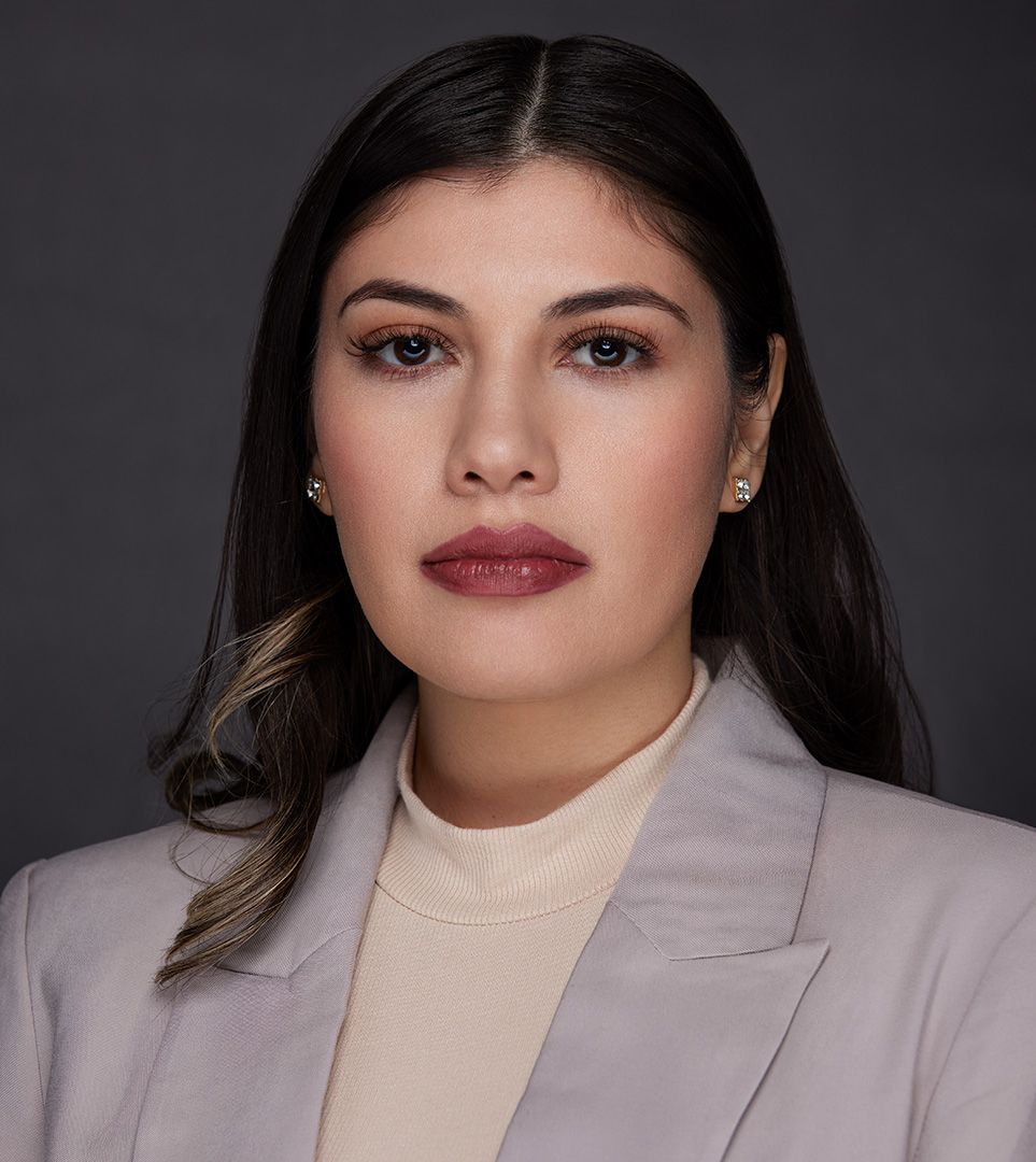 Sophisticated portrait in cream turtleneck and light blazer with polished makeup.