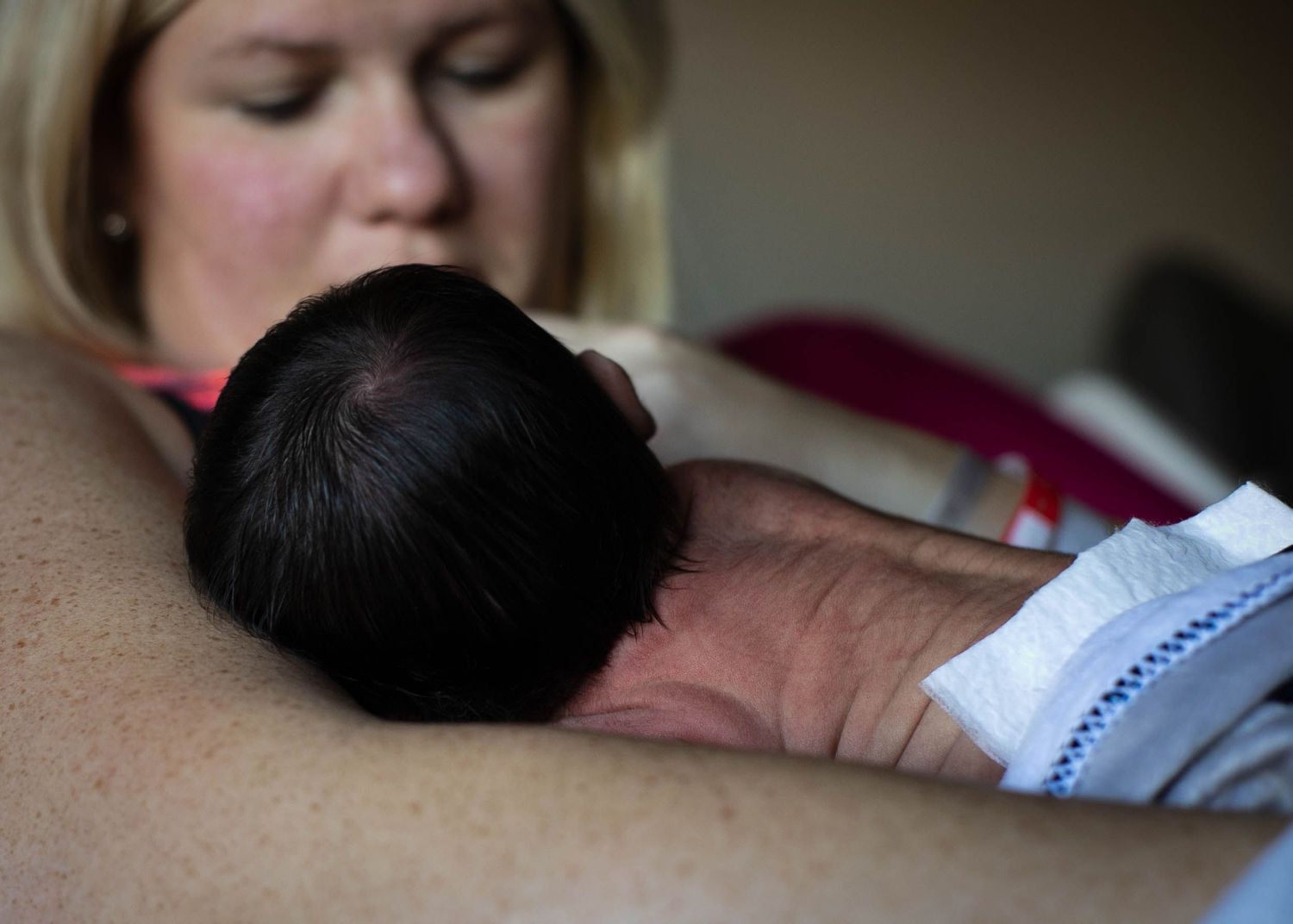 Mom holding her newborn son the day after birth during his fresh 48 session in Sioux City, IA.