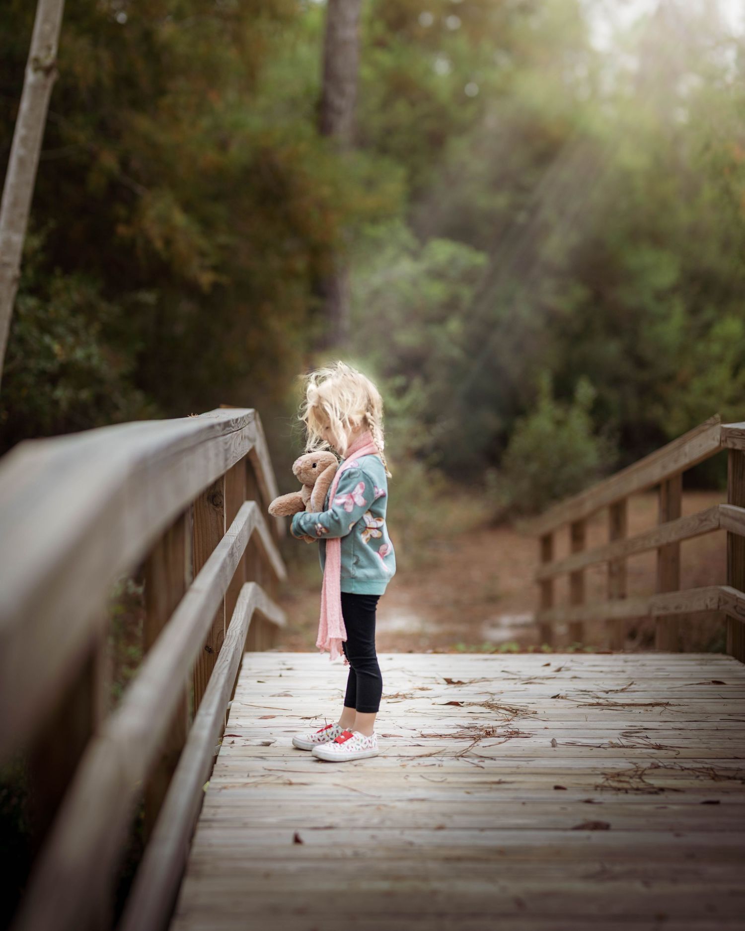 Little Girl on Bridge with Stuffed Rabbit