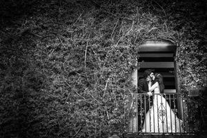 Bride and Groom kissing on the balcony