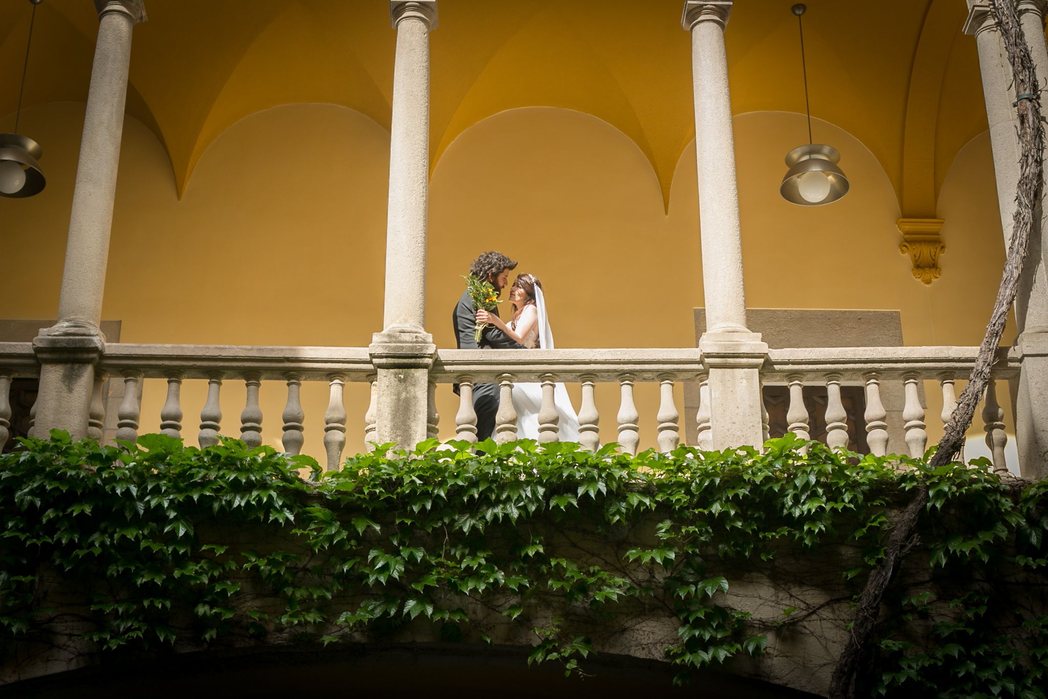 Bride and Groom look lovingly at each other on the balcony