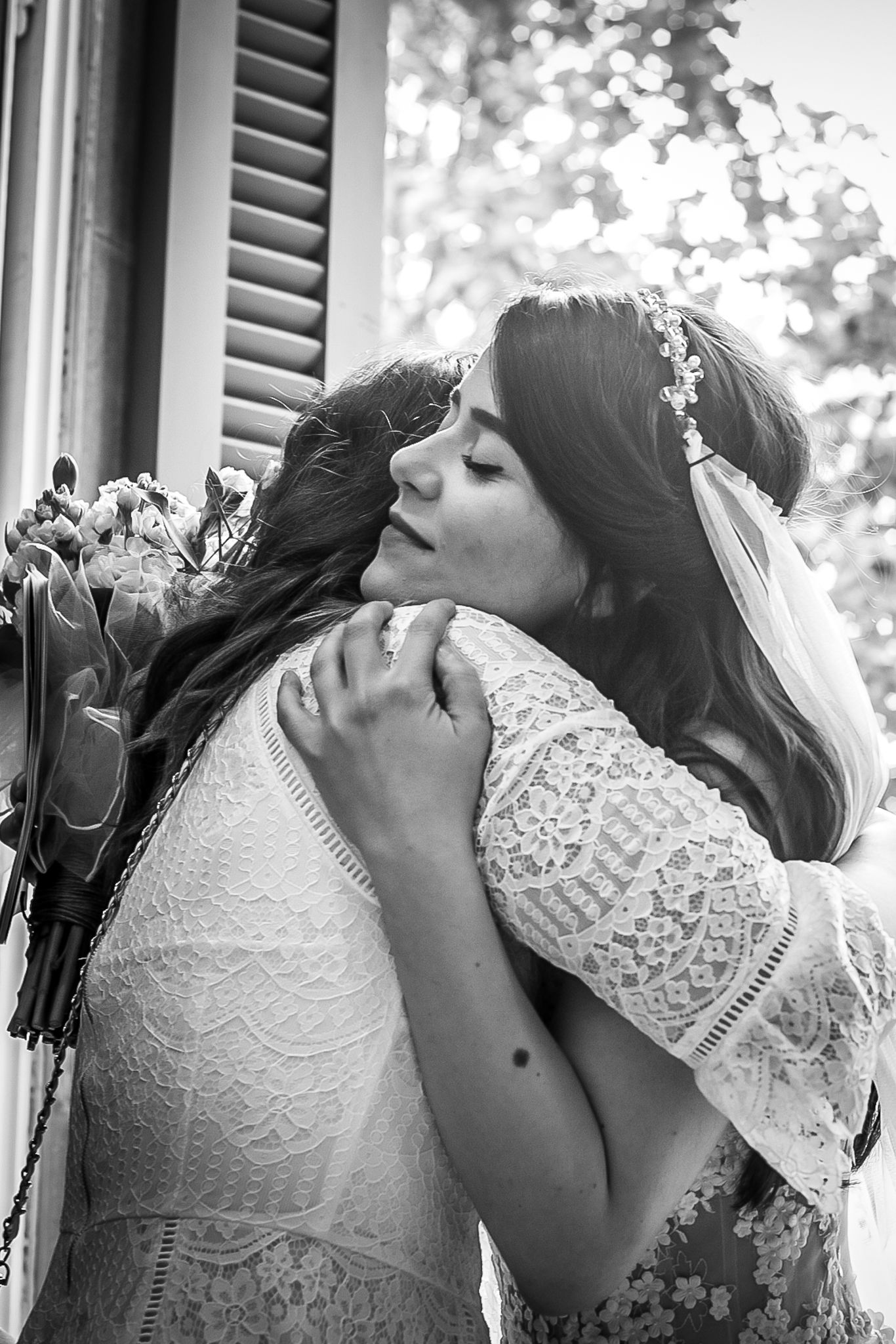 Bride hugging her friend after getting married