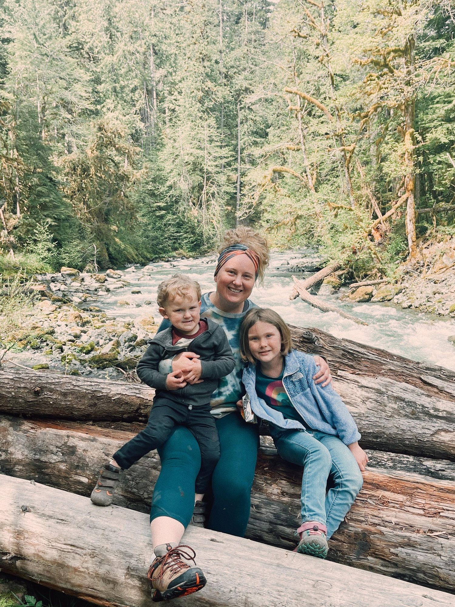 Tori Shults with two kids taking a break near a river