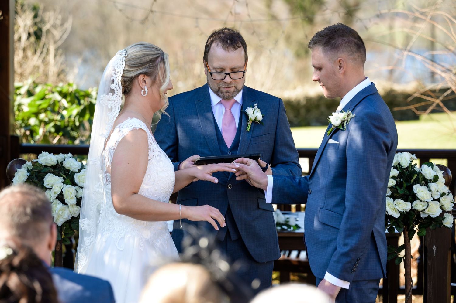 Couple exchanging rings during Lake District wedding